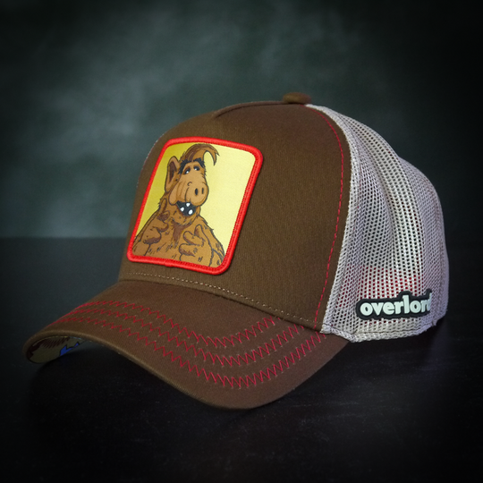 Brown twill trucker cap with khaki mesh featuring a woven patch of ALF attached to the crown.