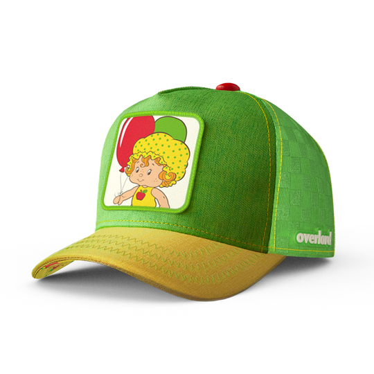 Green and yellow linen trucker cap hat featuring Apple Dumplin' from Strawberry Shortcake on square woven patch attached to crown.