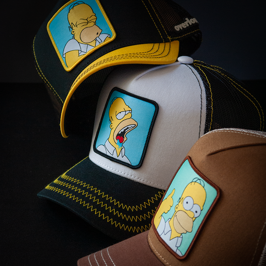 Black and yellow OVERLORD X The Simpsons Homer Doh trucker baseball cap hat with black stitching. PVC Overlord logo.