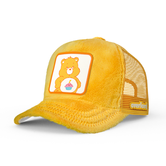 Yellow faux fur trucker cap hat featuring Birthday Bear from Care Bears on woven patch attached to crown