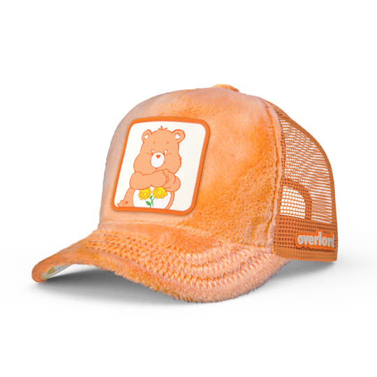 Orange faux fur trucker cap featuring a woven patch of Friendship Bear from Care Bears attached to the crown.