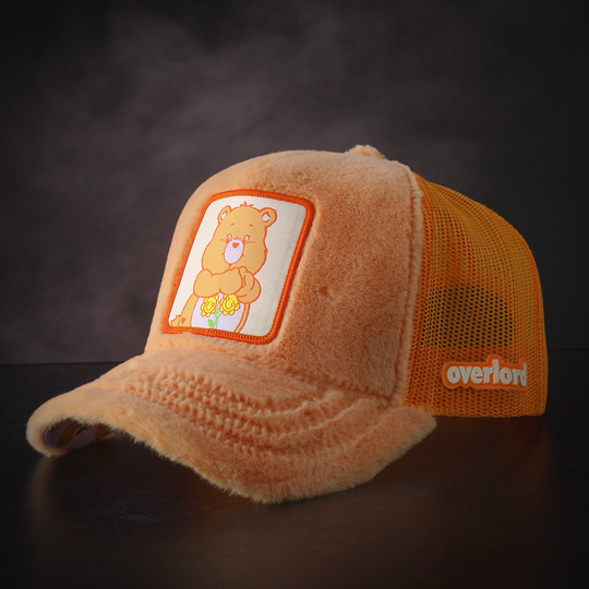 Orange faux fur trucker cap featuring a woven patch of Friendship Bear from Care Bears attached to the crown.