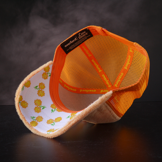 Inside view of orange faux fur trucker cap with yellow flowers on white underbrim