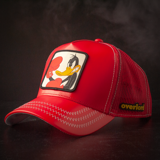 Red faux leather trucker cap hat with Looney Tunes Boxing Daffy Duck woven patch against a black background