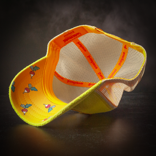 Inside view of yellow fleece trucker cap hat with Fraggle Rock beets printed fabric on underbrim.