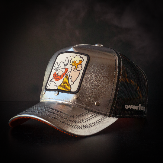 Metallic silver trucker cap hat with Hagar the Horrible woven patch against a black background