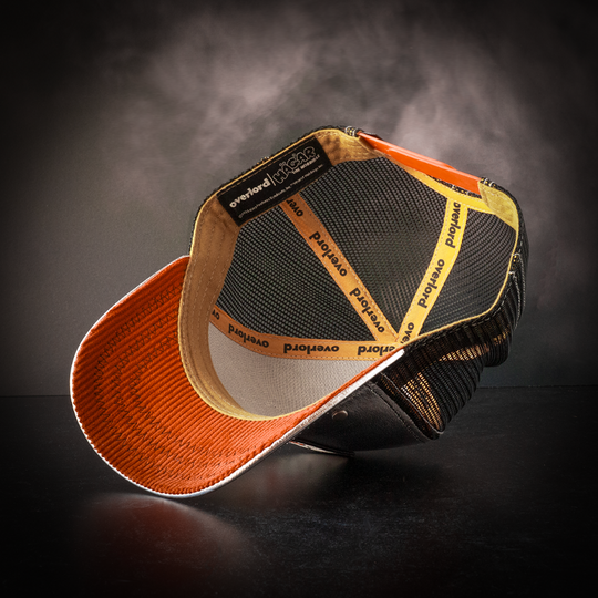 Inside view of metallic silver trucker cap hat with orange corduroy fabric underbrim
