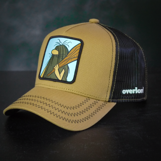Light brown twill trucker cap with black mesh featuring a woven patch of Captain Caveman from the classic Hanna-Barbera cartoons attached to the crown.