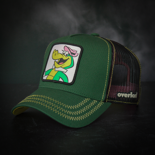 Dark green twill trucker cap with black mesh featuring a woven patch of Wally Gator from the classic Hanna-Barbera cartoons attached to the crown.