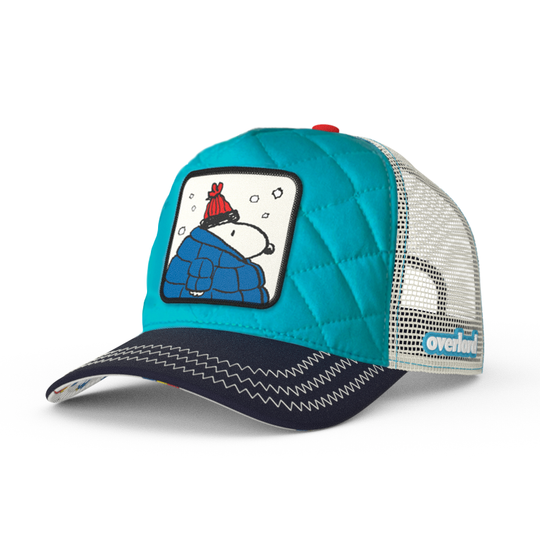 Quilted blue trucker cap hat with Peanuts Snoopy in blue jacket woven patch against a white background