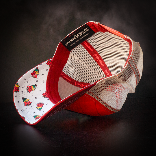 Inside view of quilted red trucker cap hat with Peanuts Woodstock in red jacket printed fabric underbrim.