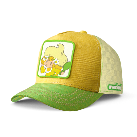 Yellow and green linen trucker cap hat with Lemon Meringue from Strawberry Shortcake on woven patch against a white background