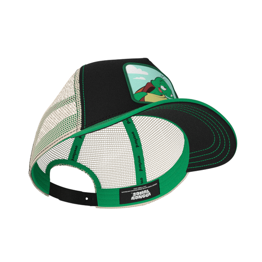 Black and green twill trucker cap with khaki mesh featuring a woven patch of Cecile the Turtle from the Looney Tunes attached to the crown.