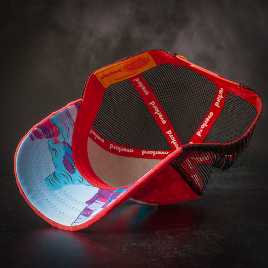 Inside view of red plush minky trucker cap hat with Muno's world printed on the underbrim