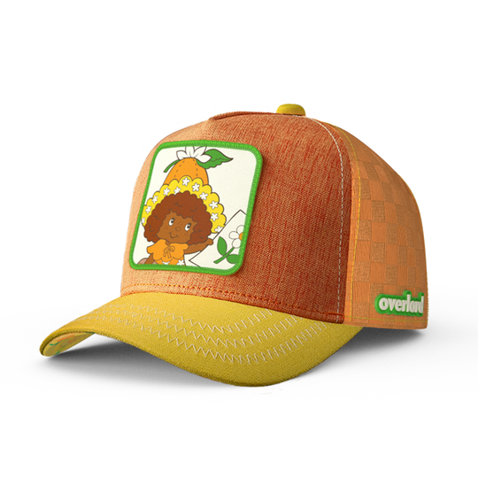A trucker cap in orange and yellow linen, featuring a woven patch of Orange Blossom character from Strawberry Shortcake.