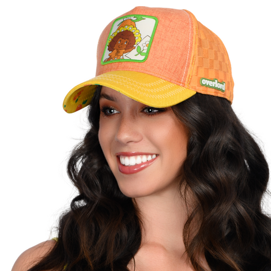 Orange and yellow linen trucker cap hat with Orange Blossom from Strawberry Shortcake on woven patch against a white background