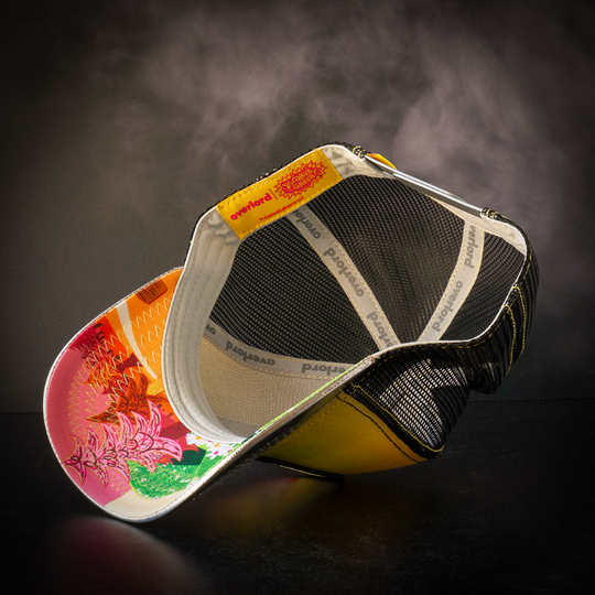 Inside view of metallic yellow and silver trucker cap with Plex's world printed on underbrim