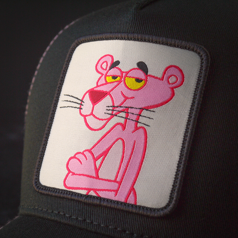 Close-up of a woven patch of Pink Panther attached to the trucker cap crown.