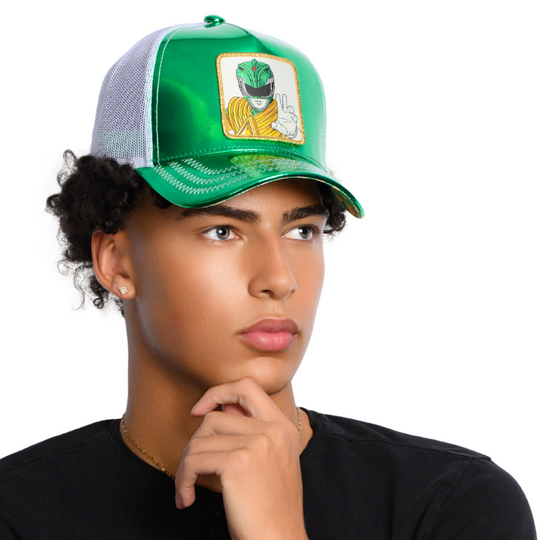Man wearing a shiny metallic green faux leather trucker cap featuring a Power Rangers Green Ranger woven patch on crown.