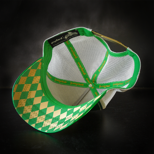 Inside view of shiny metallic green faux leather trucker cap with green and gold diamond pattern on underbrim