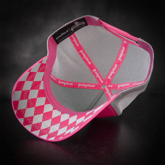 Shiny pink faux leather trucker cap with a pink and white diamond pattern on the underbrim