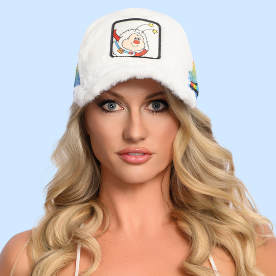 Woman wearing white faux fur trucker cap hat with rainbow mesh featuring Twink from Rainbow Brite on woven patch attached to crown