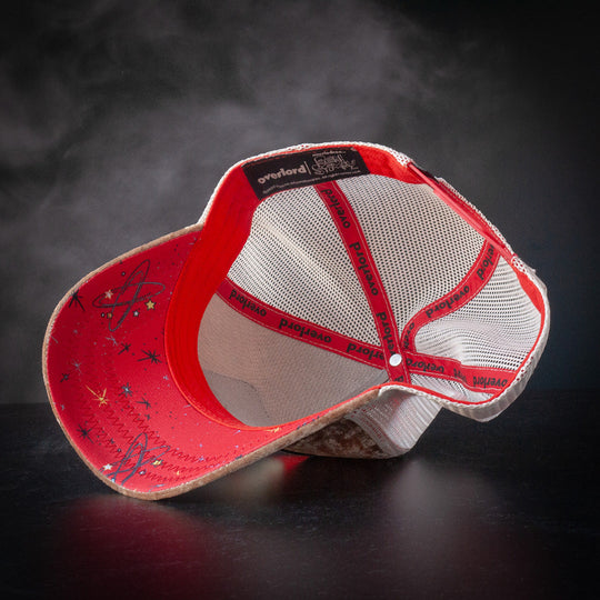 Inside view of brown crushed velvet cap hat with red atomic space symbols printed on the underbrim