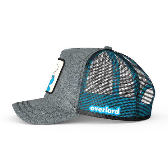 Heather gray trucker cap with black mesh featuring a woven patch of Grouchy Smurf from the Smurfs attached to crown