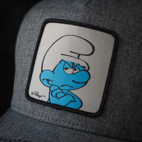 Close-up of a woven patch of Grouchy Smurf from the Smurfs attached to trucker cap crown