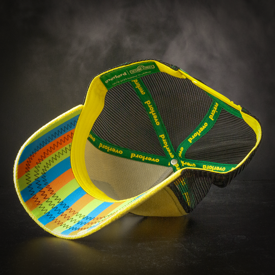 Inside view of yellow fleece trucker cap hat with striped printed fabric underbrim