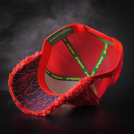 Inside view of red faux fur trucker cap hat with hand drawn hearts printed on the underbrim