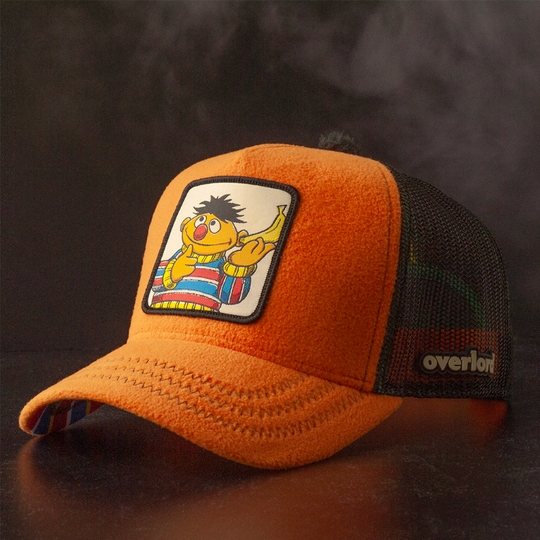 Orange fleece trucker cap hat with Sesame Street Ernie woven patch against a black background