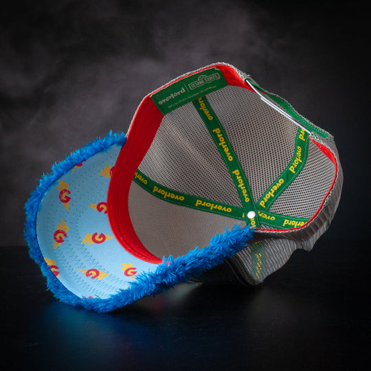Inside view of metallic silver and blue faux fur trucker cap hat with Super Grover symbols printed on the underbrim