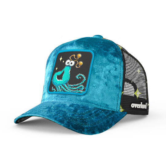 Blue crushed velvet trucker cap hat with Sesame Street blue yip martian woven patch against white background