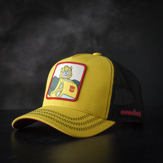 Yellow trucker cap hat featuring Bumblebee from Transformers on woven patch attached to crown