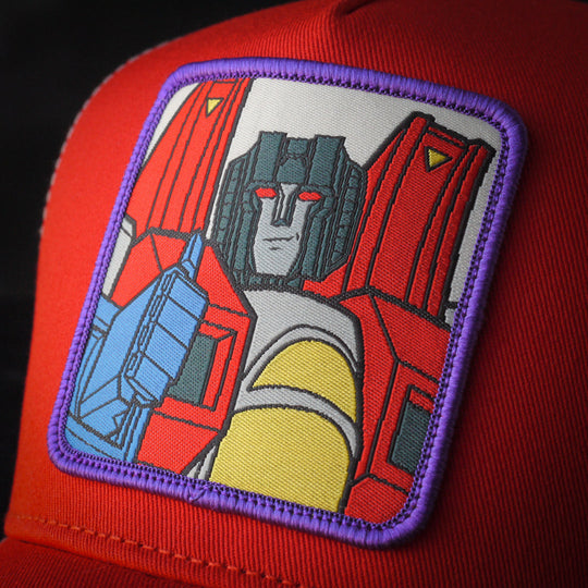 Close-up of Starscream from Transformers on woven patch attached to trucker cap crown