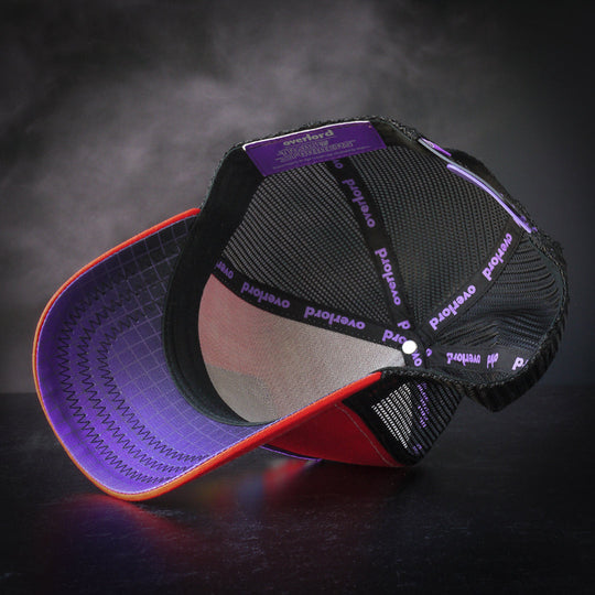 Inside view of red trucker cap hat with black and purple gradient grid printed on the underbrim.
