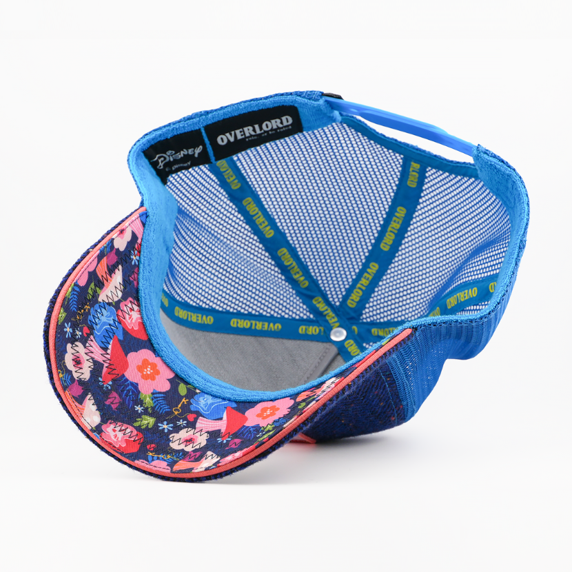 Blue cap with floral brim and mesh back on a white background