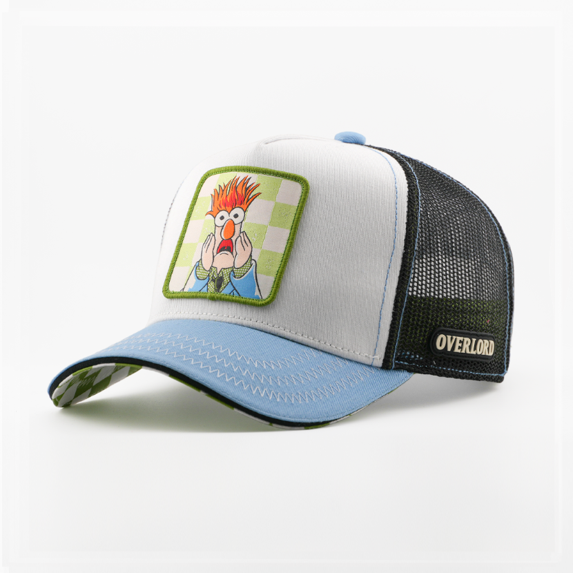 White retro trucker cap with a solid light blue brim and a patch of Beaker from The Muppets looking startled on a green checkered background, black mesh back with tan Overlord logo.