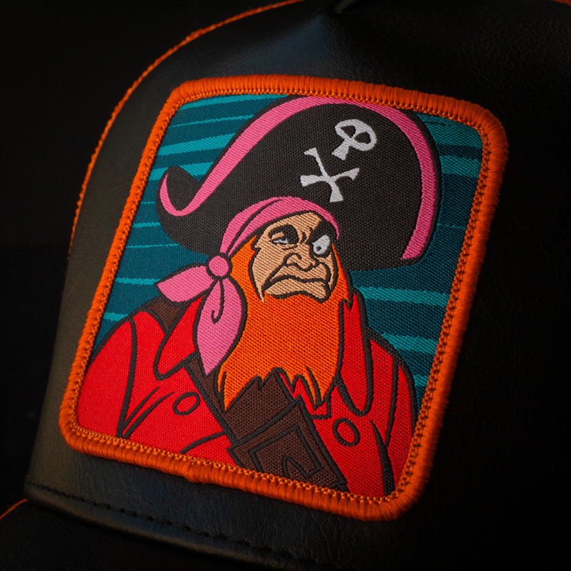 Close-up of a woven patch of Red Beard villain from Scooby Doo attached to the crown.