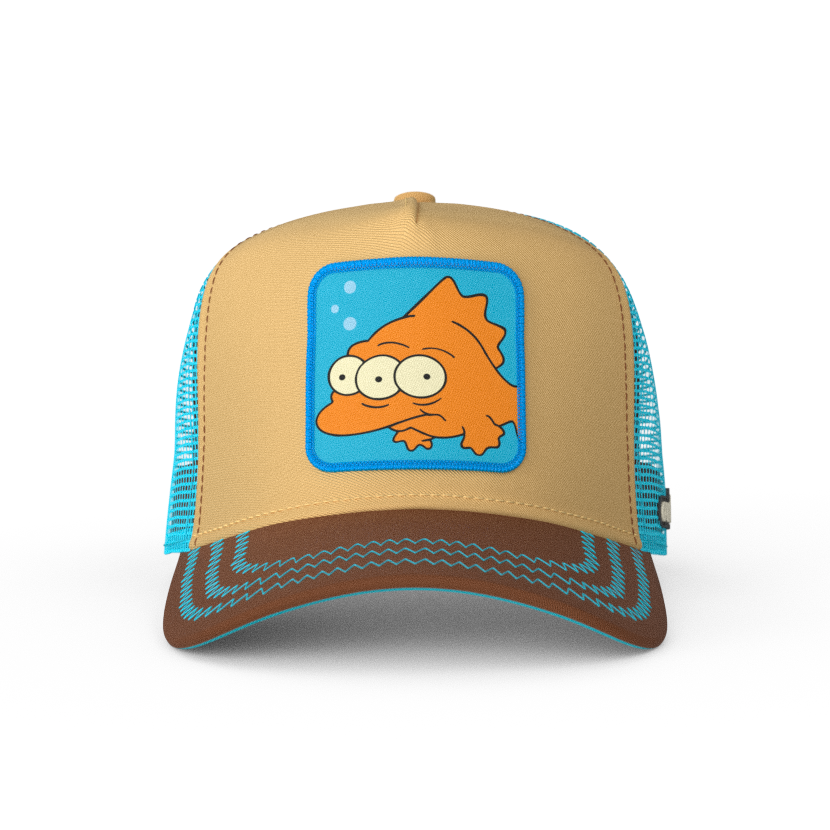Tan and brown OVERLORD X The Simpsons Blinky the three-eyed fish trucker cap hat with aqua zig zag stitching. PVC Overlord logo.