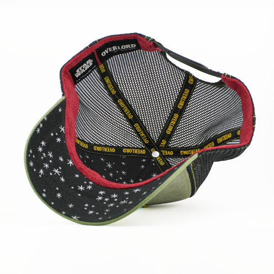 Underside of the Boba Fett trucker cap showing a starry black brim print with Star Wars tag, maroon trim, black mesh crown, and yellow Overlord taping.