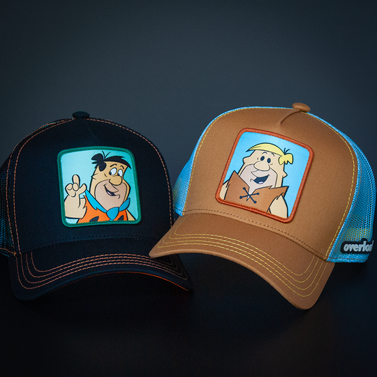 Brown OVERLORD X Flintstones Barney Rubble trucker baseball cap with yellow stitching. PVC Overlord logo.
