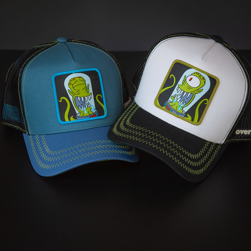 Blue OVERLORD X The Simpsons present Kodos the alien trucker baseball cap hat with lime green zig zag stitching. PVC Overlord logo.