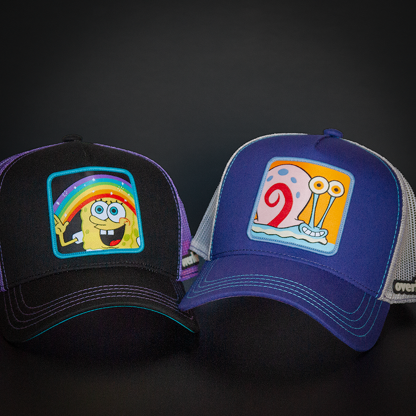 Black OVERLORD X SpongeBob Imagination SpongeBob holding a rainbow trucker baseball cap hat with purple stitching. PVC Overlord logo.