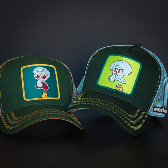Dark green OVERLORD X SpongeBob Squidward surprised face trucker baseball cap with yellow zig zag stitching. PVC Overlord logo.
