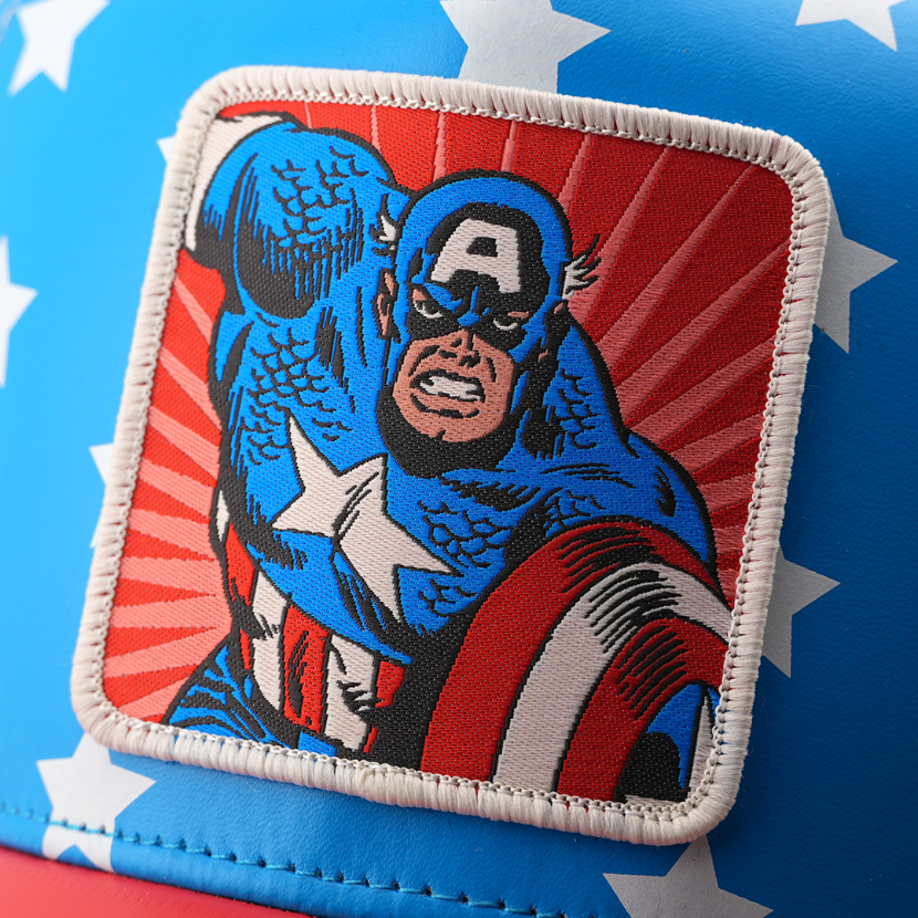 Close-up of a woven Marvel's Captain America patch with radiating red rays, stitched onto star-print blue cap fabric.