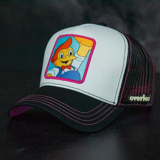 White and black OVERLORD X The Simpsons Lard Lad holding donut trucker baseball cap hat with pink stitching. PVC Overlord logo.