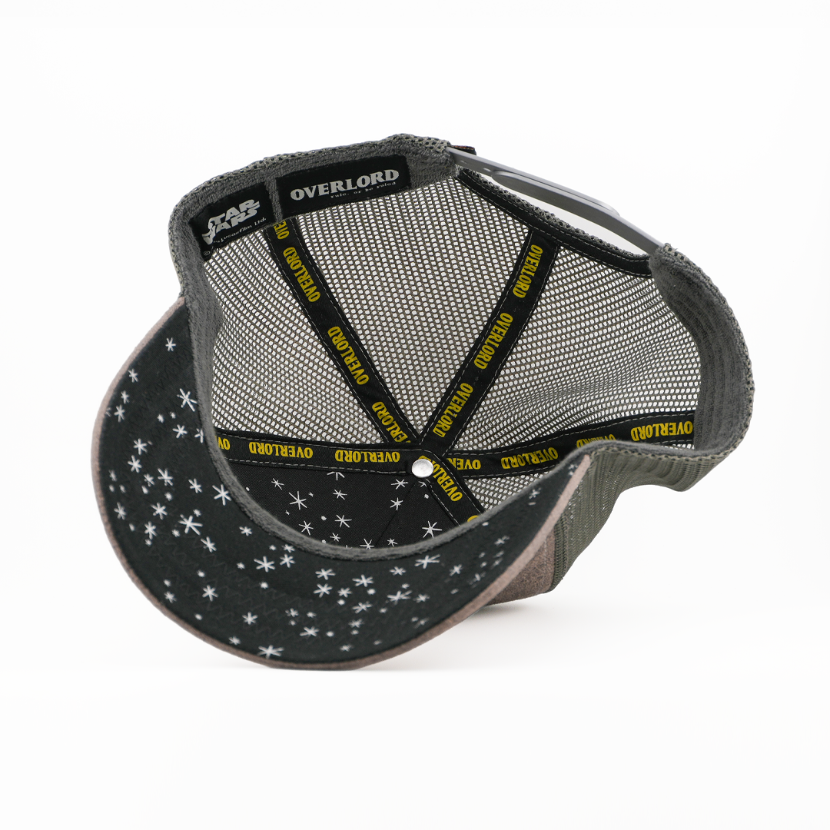 Underside of the Han Solo in Carbonite trucker cap showing a starry black brim print with Star Wars tag, gray mesh crown, and yellow Overlord taping.