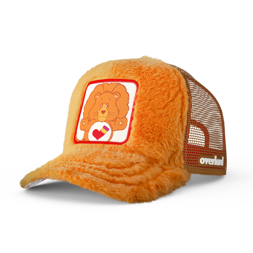 Orange plush trucker cap hat with Braveheart Lion woven patch against a white background